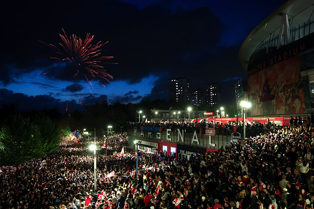 Fans celebrate as Arsenal are confirmed as Premier League champions, as they gather outside the Emirates Stadium, on May 19, 2026 in London, England.