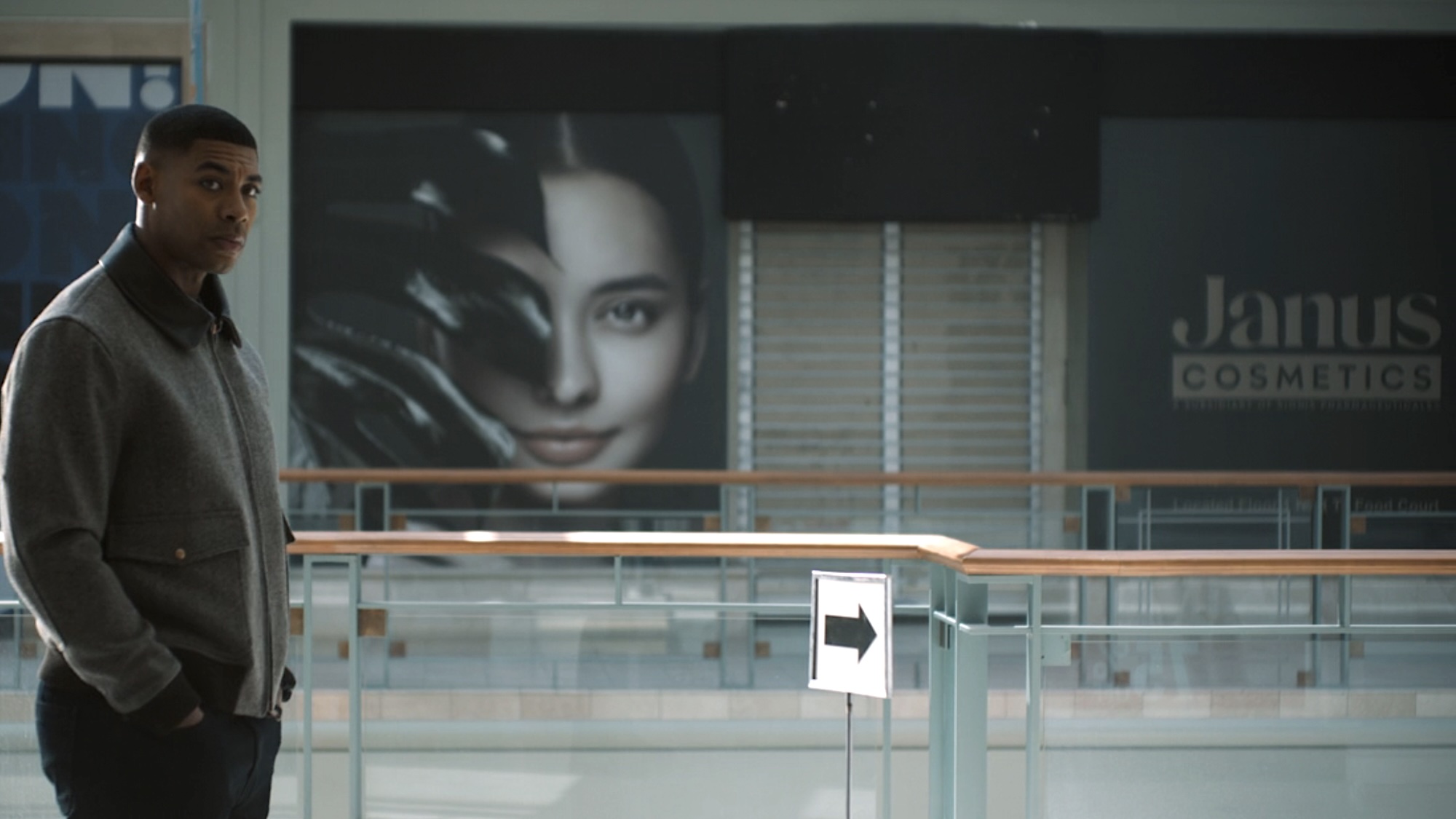John Stewart standing in abandoned mall with closed-down Janus Cosmetics store in the background in Lanterns Episode 3