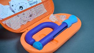 Colourful orange insulin kit containing an insulin pen and temporary tattoos for children 