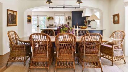 dining space with basket chairs and arch to kitchen