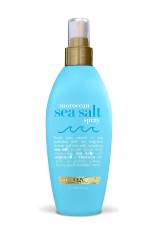 A bottle of OGX moroccan sea salt spray set against a white background.