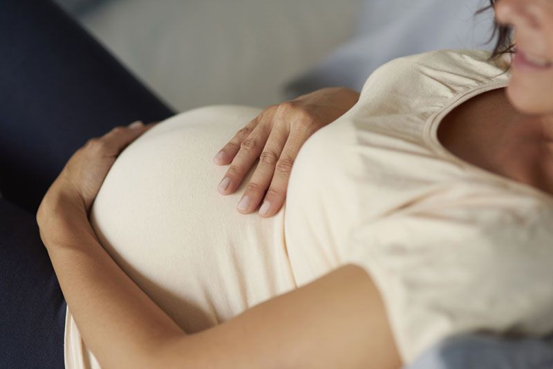 A pregnant woman lying down.