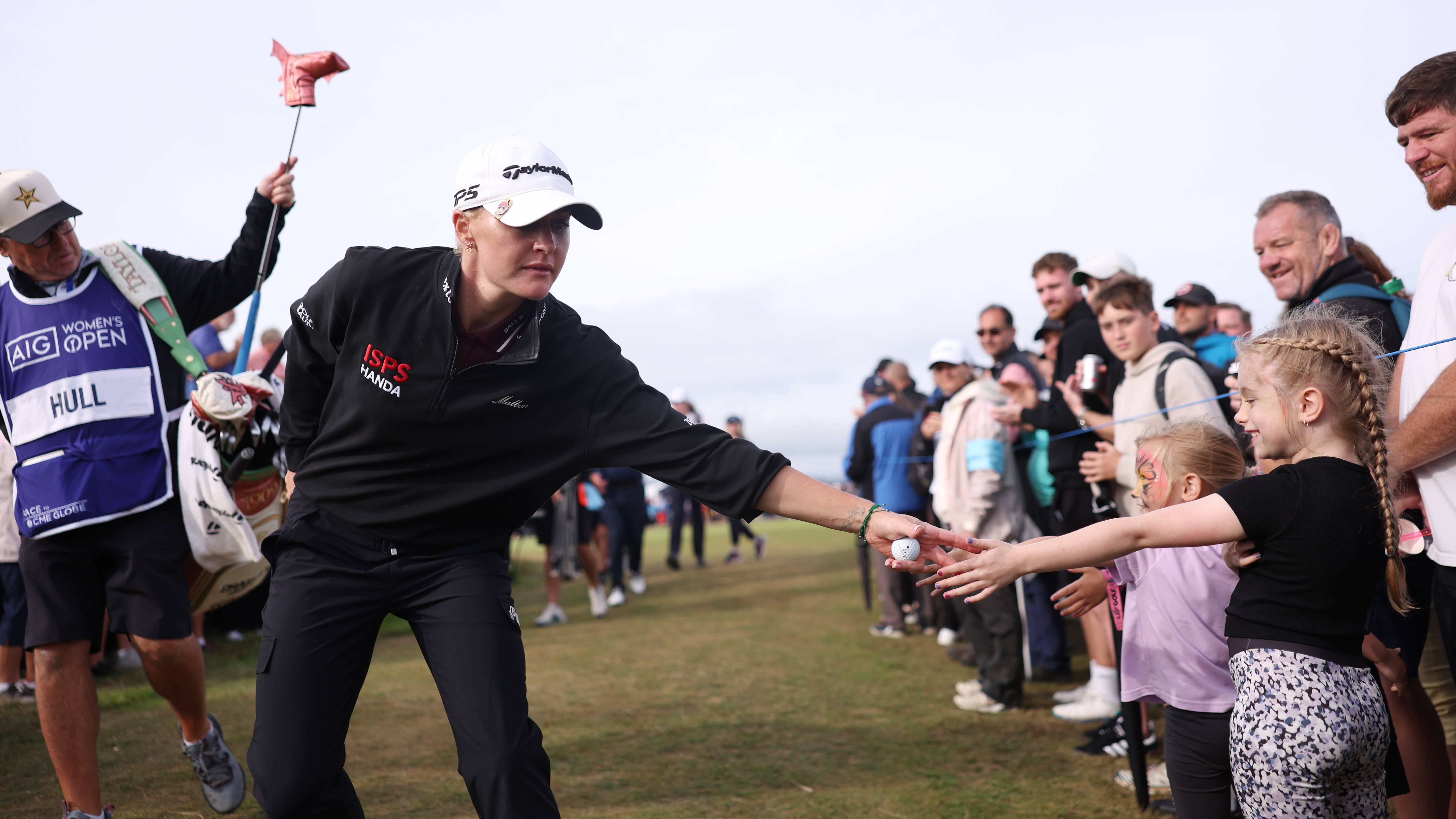 Charley Hull high fives a young fan during the final round of the AIG Women's Open