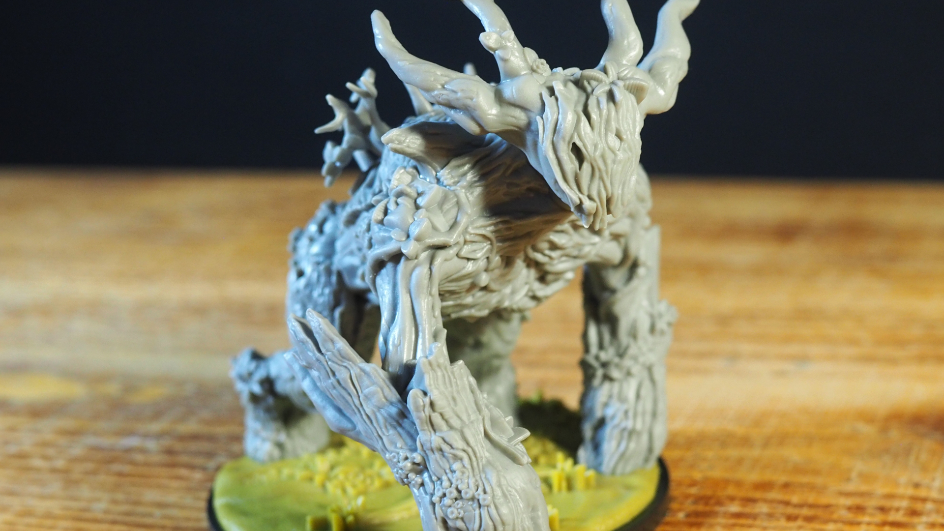 A treelike monster miniature, against a dark background