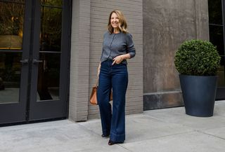 Sandy Koszarek wearing a gray crewneck cardigan and wide-leg jeans.