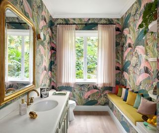 bathroom with jungle print wallpaper and mustard bench seat