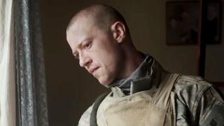 Joseph Quinn peering out the window in Warfare