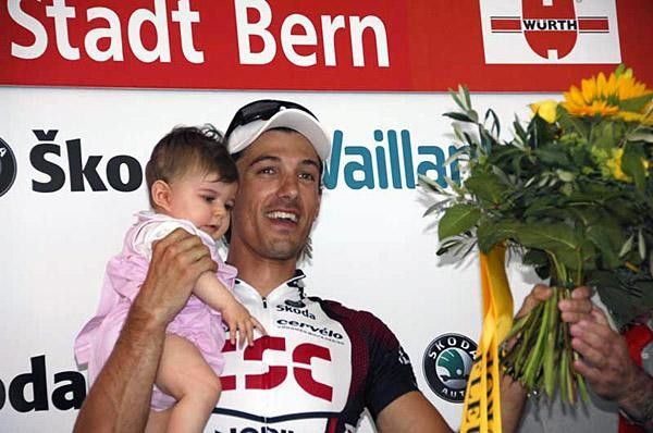 Cancellara and child on the stage winner's podium
