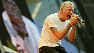 Chester Bennington singing onstage with Linkin Park in 2003