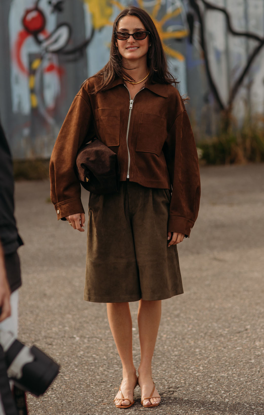 Woman in suede jacket and suede culottes