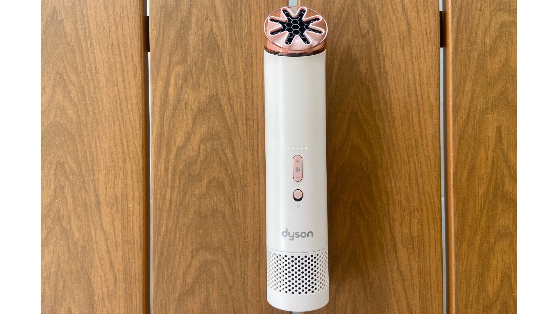The Dyson HushJet Mini Cool Fan on wooden boards