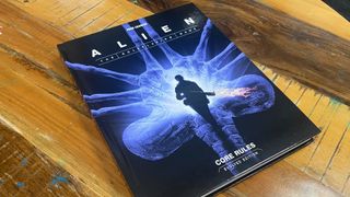 Alien RPG Evolved Edition Core Rules on a wooden surface
