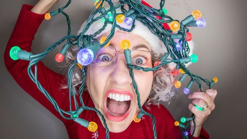 Person tangled in christmas lights