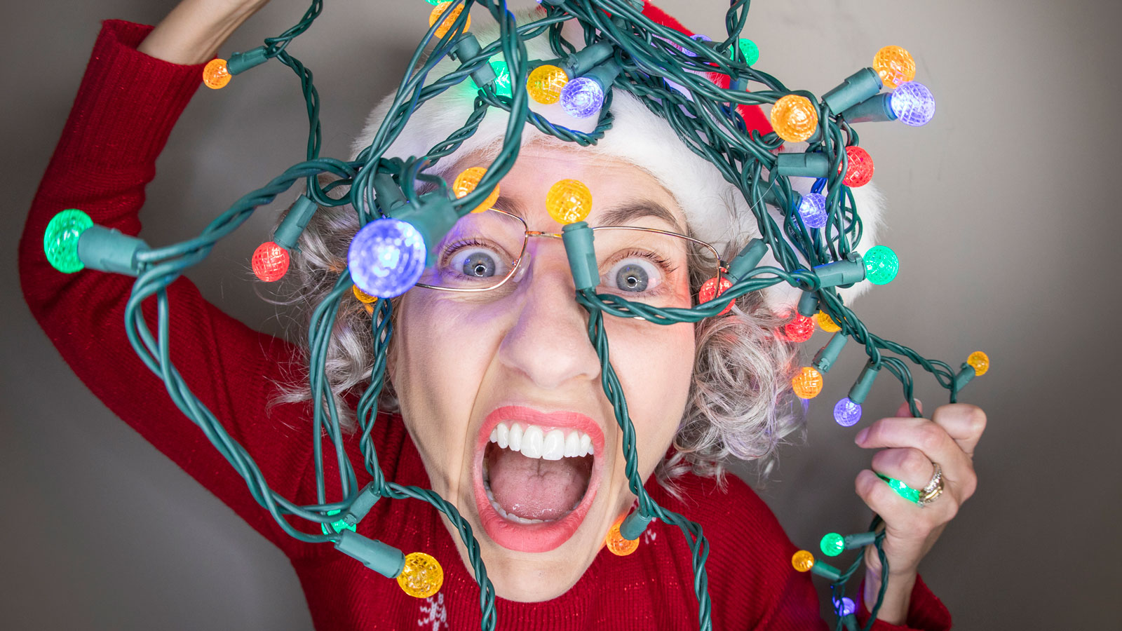 Person tangled in christmas lights
