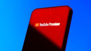 Smartphone on surface showing Youtube Premium logo