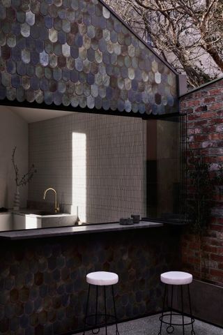 The kitchen and exterior scalloped tiles, seen from the courtyard, Nido II House, Melbourne Australia by Angelucci Architects