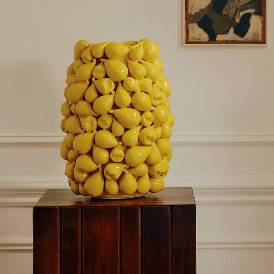 A yellow vase made of ceramic, 3-D figs