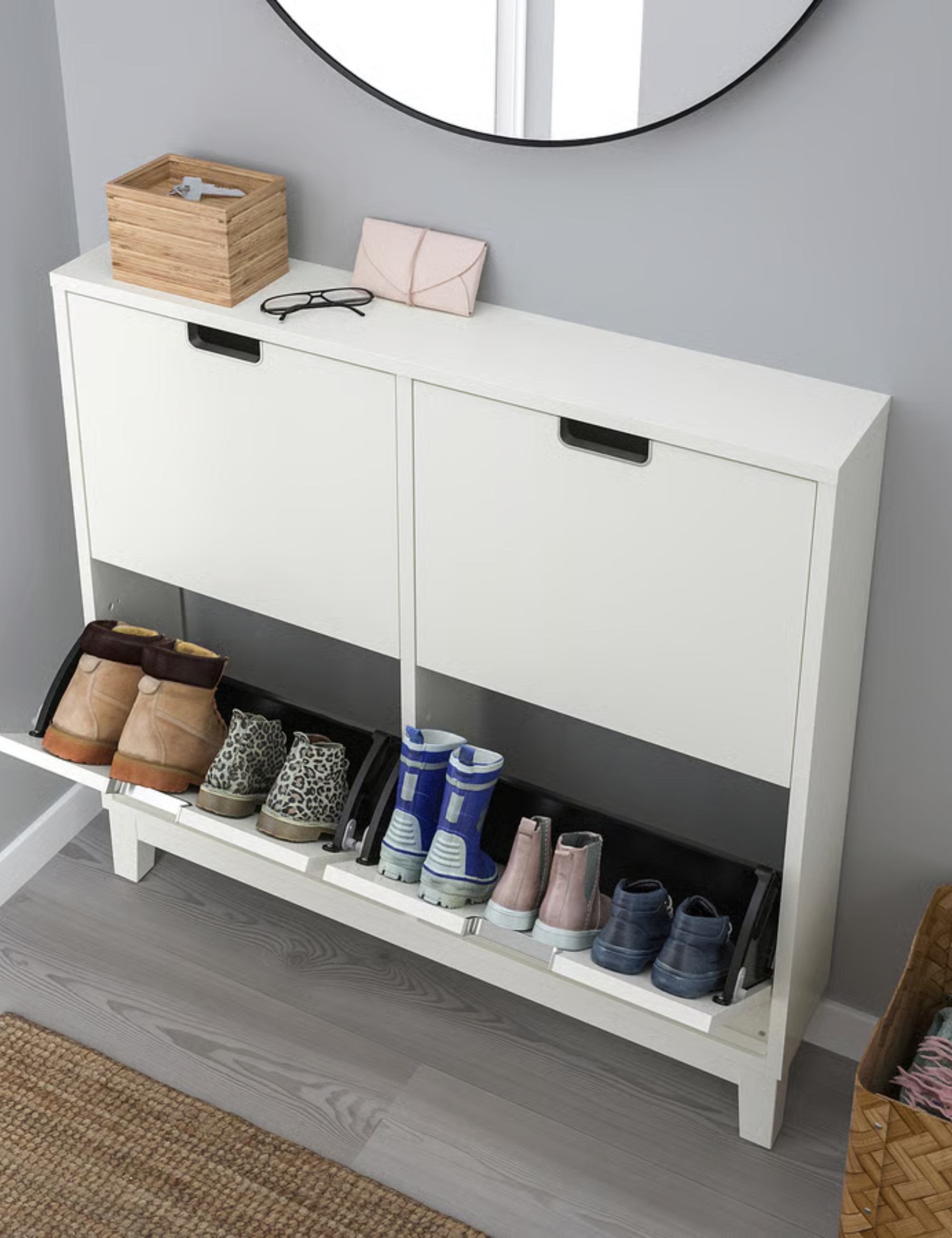 Minimalist white IKEA storage halfway opened to reveal inner shoe compartments