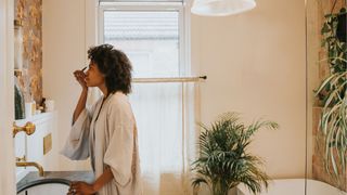 woman applying makeup