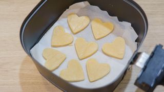 Heart-shaped biscuits in an air fryer basket
