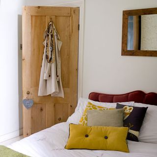main bedroom with white wall and wooden door