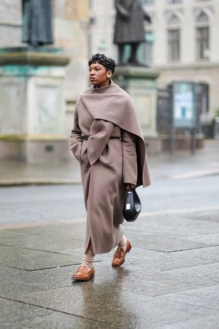 woman wearing coat, socks, and loafers