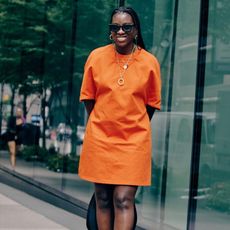 Nikki Ogunnaike wearing an orange dress