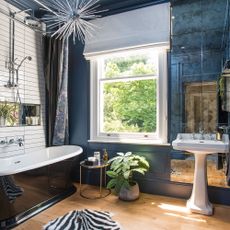 blue panelled bathroom with freestanding bath