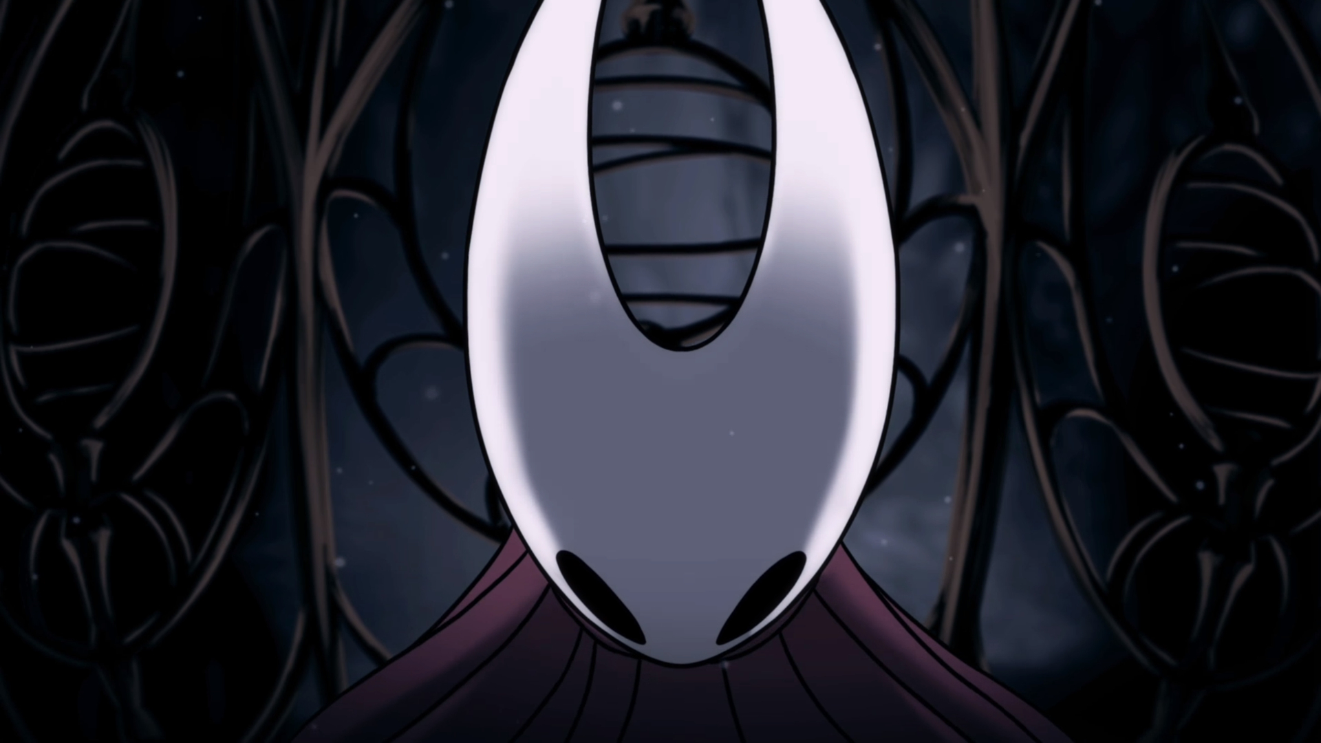 Hornet, head lowered, in Hollow Knight: Silksong within her cage in the opening cutscene