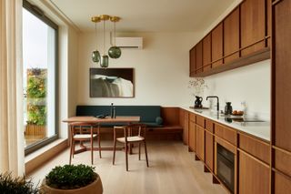 A kitchen with built in seating by the wall