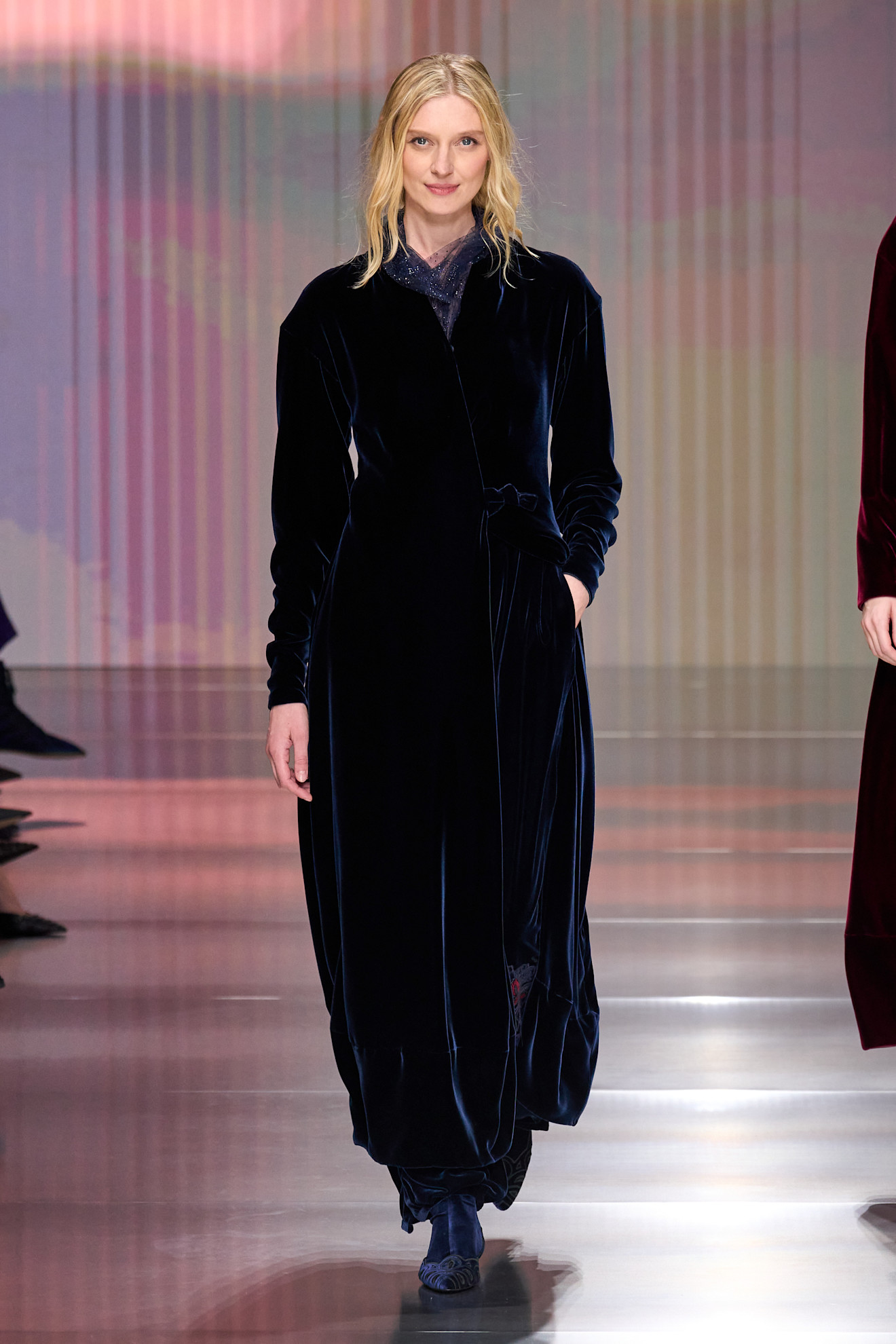 a woman walks the giorgio armani fall/winter 2026 show.