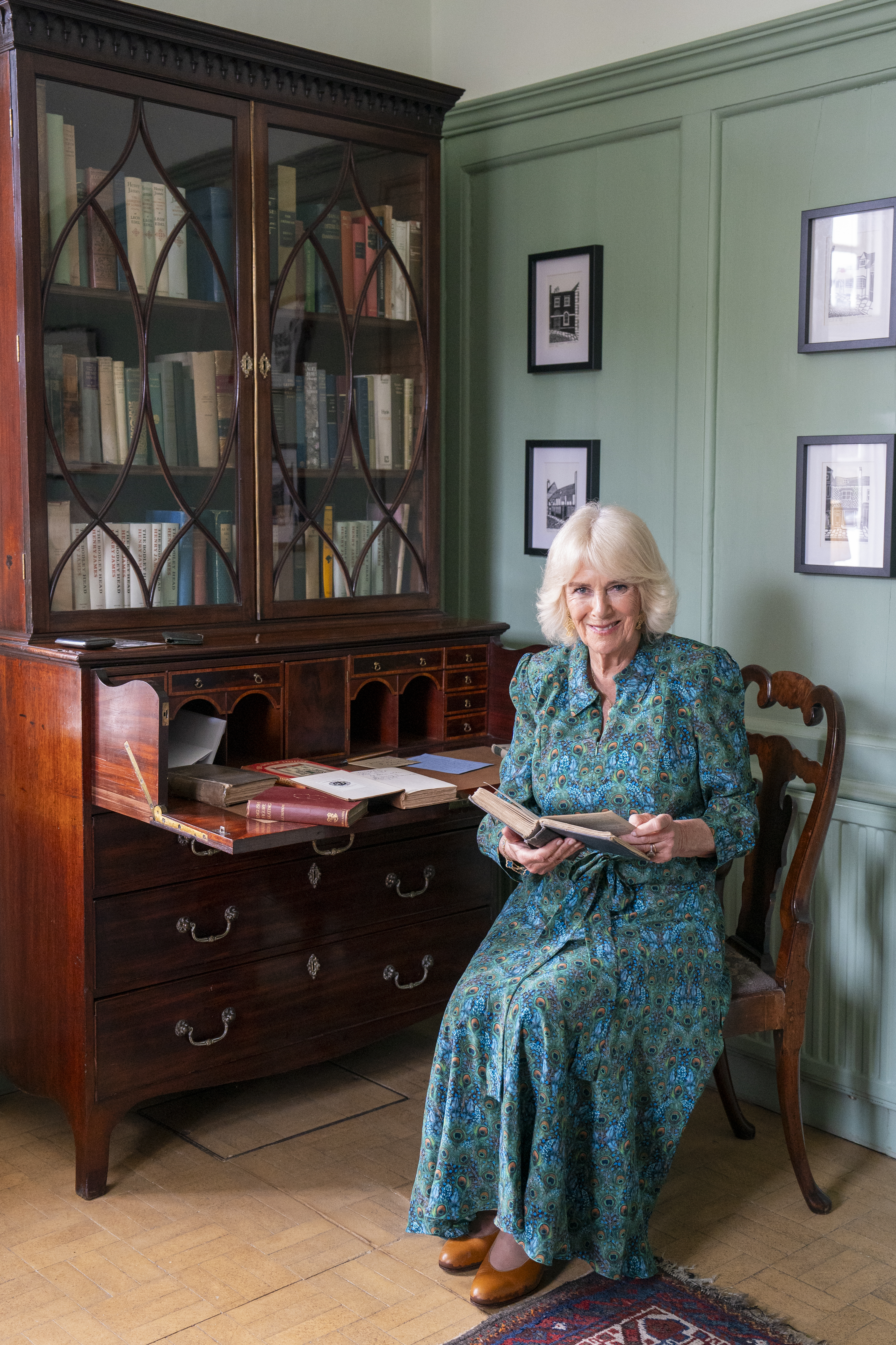 RYE, ENGLAND - MAY 16: Queen Camilla is seen looking at a first edition of a Henry James book in the library at Lamb House on May 16, 2024 in Rye, England. Her Majesty then joined guests for a garden party in celebration of Rye&amp;amp;apos;s literacy history. During the Garden Party, Gyles Brandreth, President of the Friends of Tilling, actor Timothy West and Oscar winner Hayley Mills gave readings. After departing Lamb House, Queen Camilla strolled down Rye&amp;amp;apos;s Mermaid Street. (Photo by Arthur Edwards - WPA Pool/Getty Images)