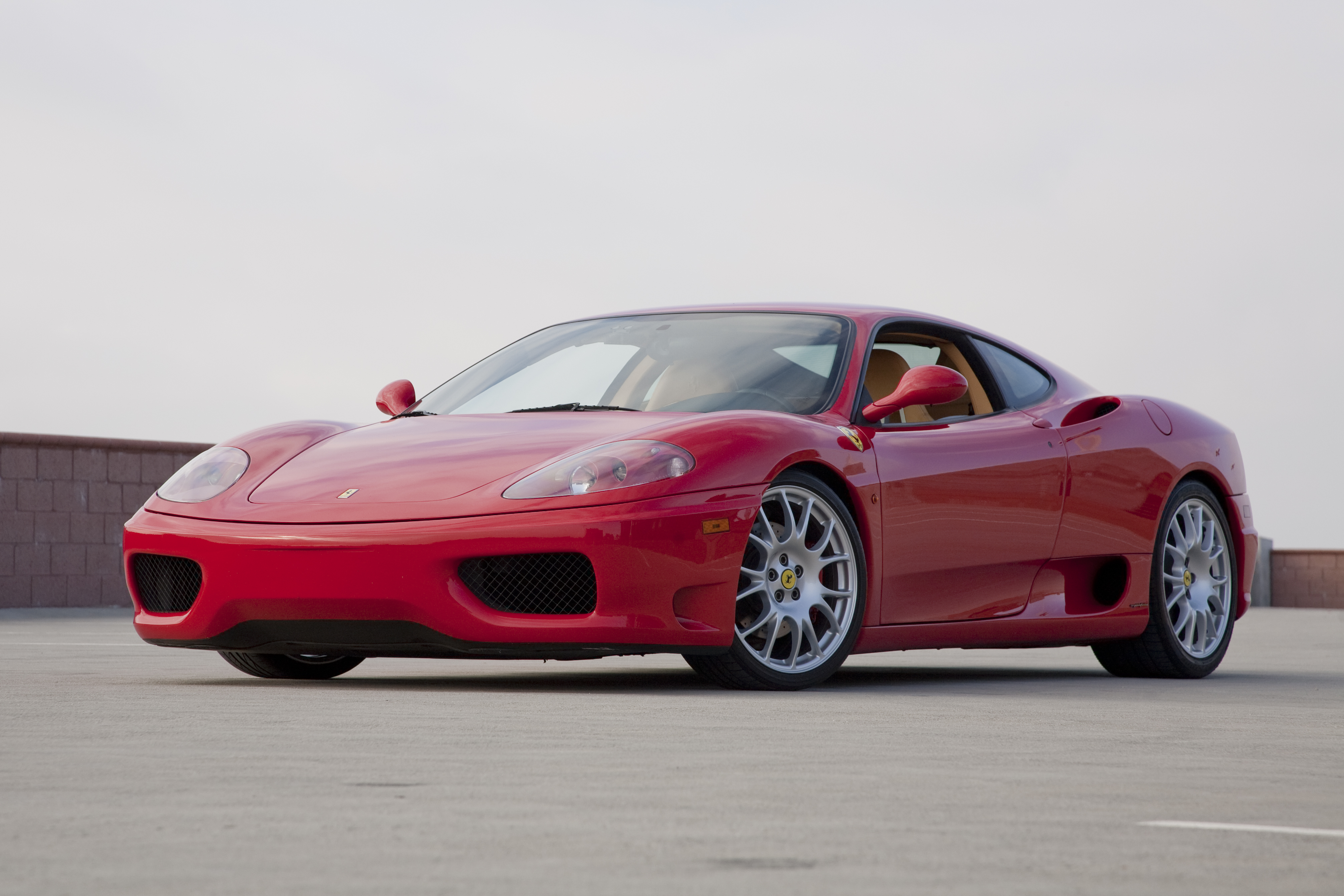 A red Ferrari 360 Modena sports car in Cerritos, CA on March 14, 2009. The 360 boasts a top speed of 186 mph due to the powerful 3.6L V8 engine.