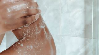 Close view of woman in shower with soap suds