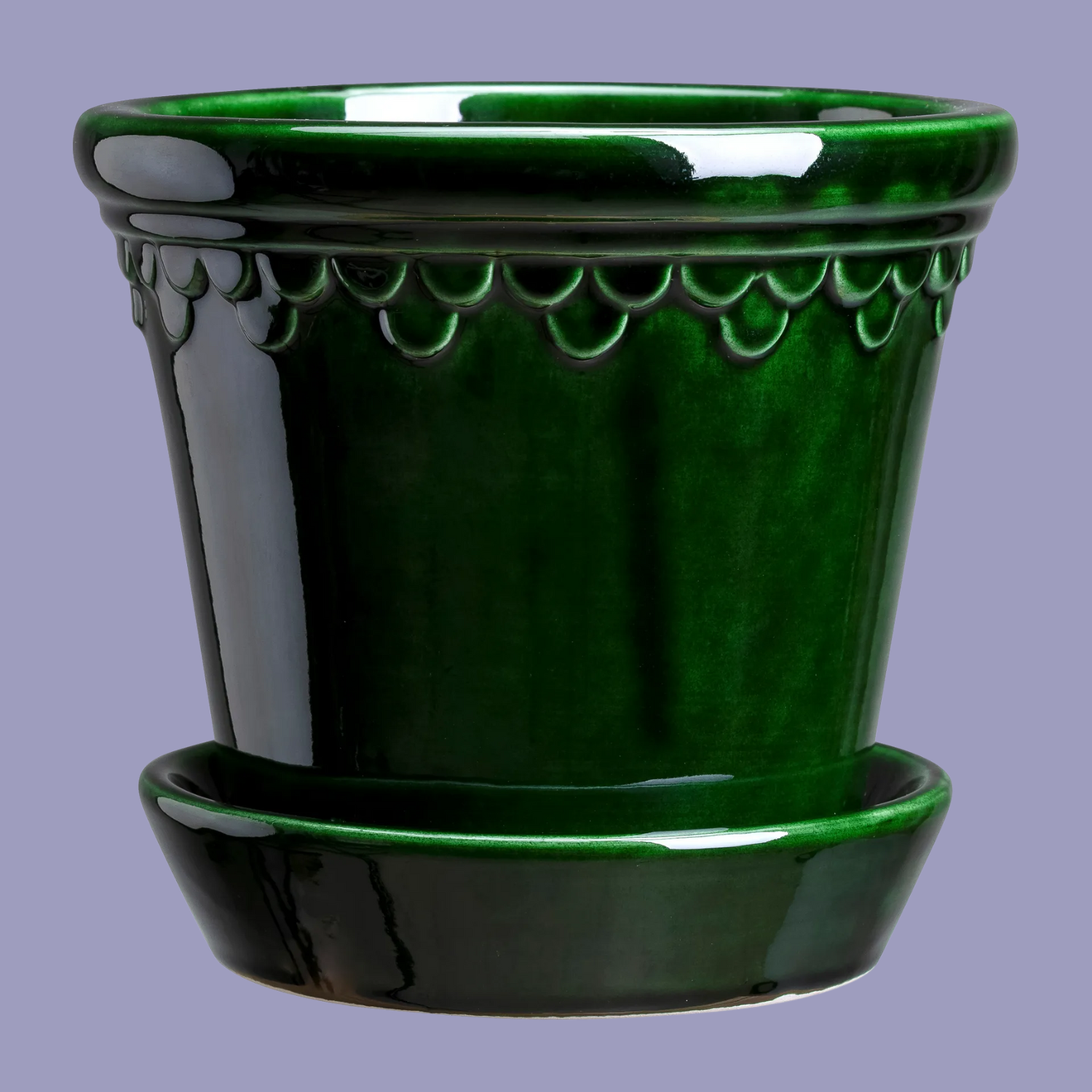 A green glazed ceramic planter with a saucer