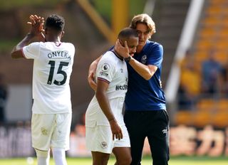 Brentford manager Thomas Frank with Bryan Mbeumo following the Premier League match at Molineux Stadium, Wolverhampton. Picture date: Saturday September 18, 2021