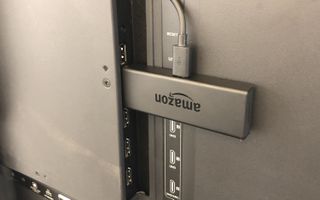 The fire tv stick plugged into a TV's HDMI port