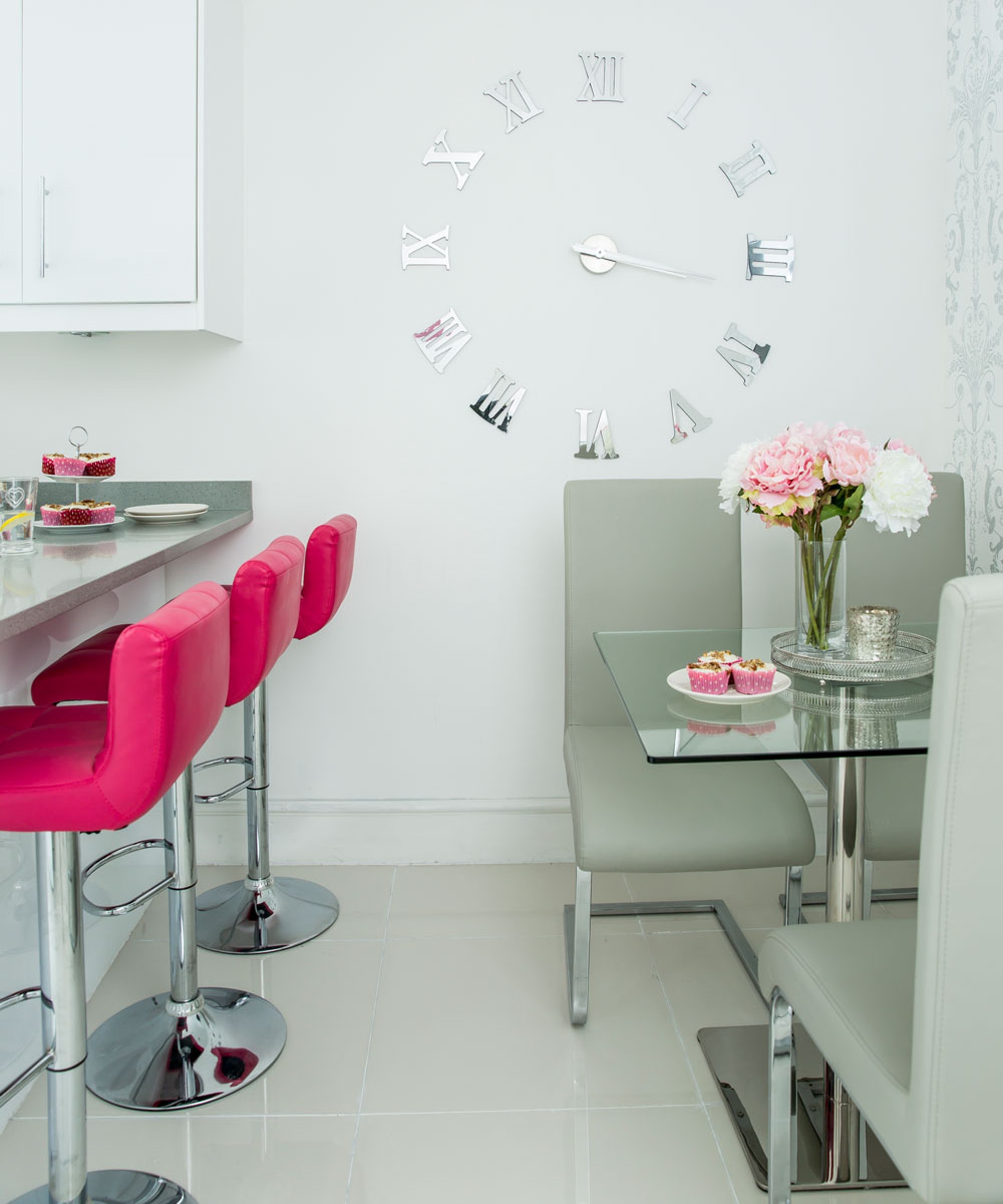 white kitchen with table and bar stools
