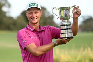 Adrian Meronk holding the Australian Open trophy