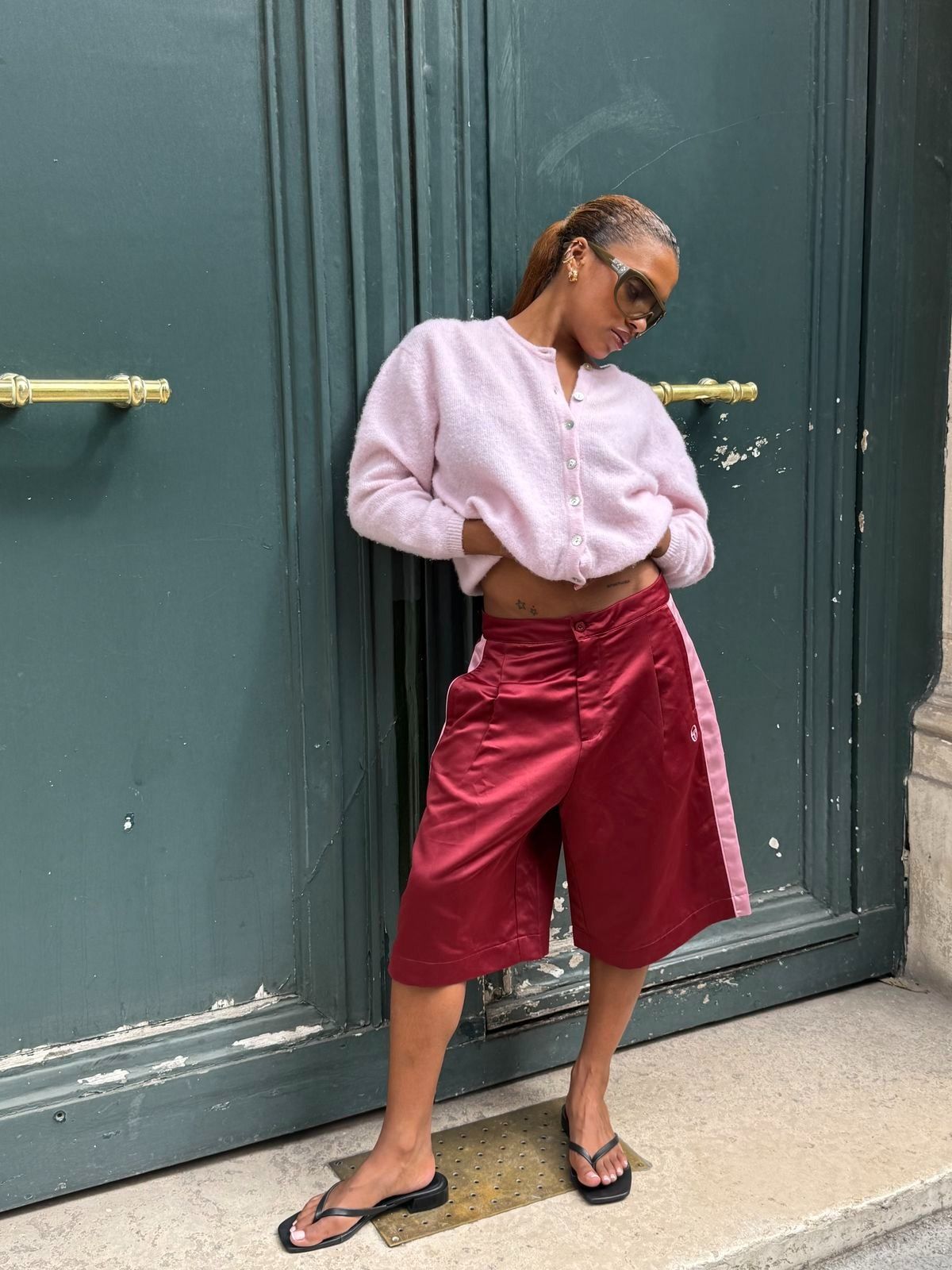 Satin Bermuda Short Trend Summer 2026 worn by MV. tiangue. She wears a maroon and pink striped pair.