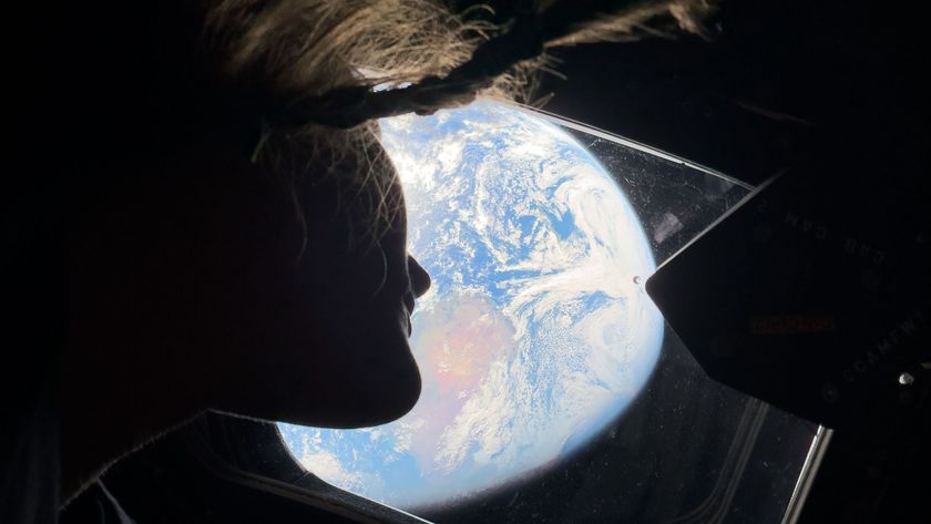 Artemis 2 astronaut Christina Koch of NASA looks at Earth as her Orion spacecraft heads toward the moon in April 2026.