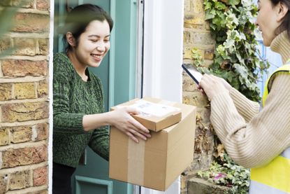 A woman receiving parcels at the door