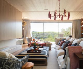 living room with low ceilings with timber clad ceilings and modern fireplace