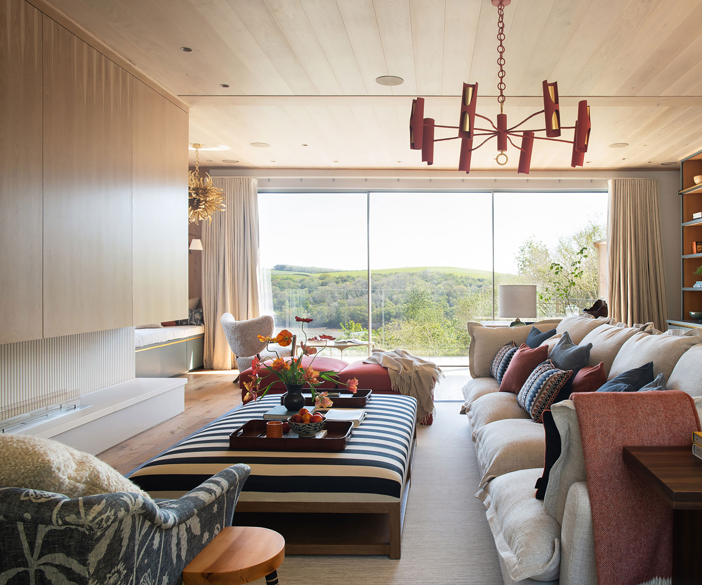 living room with low ceilings with timber clad ceilings and modern fireplace