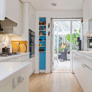 victorian home with quirky octagonal tower white kitchen with shelves and galley kitchen
