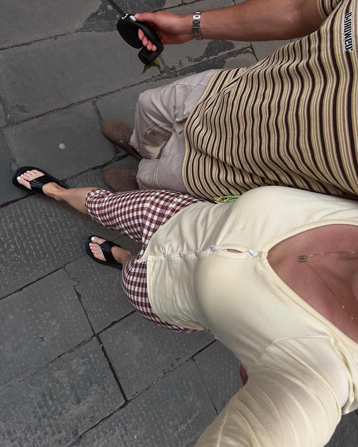 Martha Chrstian wears a yellow cardigan, gingham capri trousers and flip flops