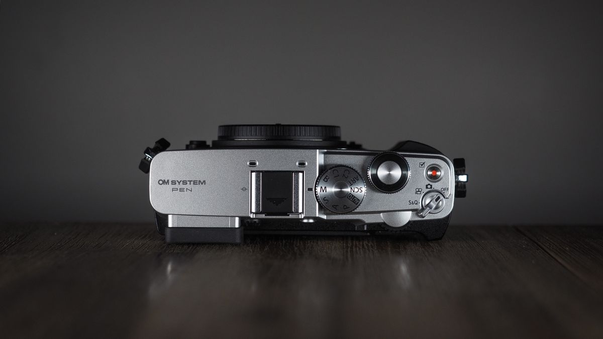 OM System OM-3 on a wooden surface