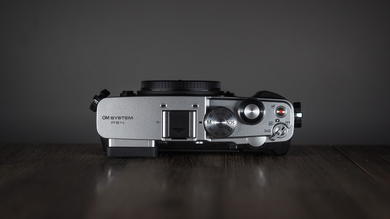 OM System OM-3 on a wooden surface