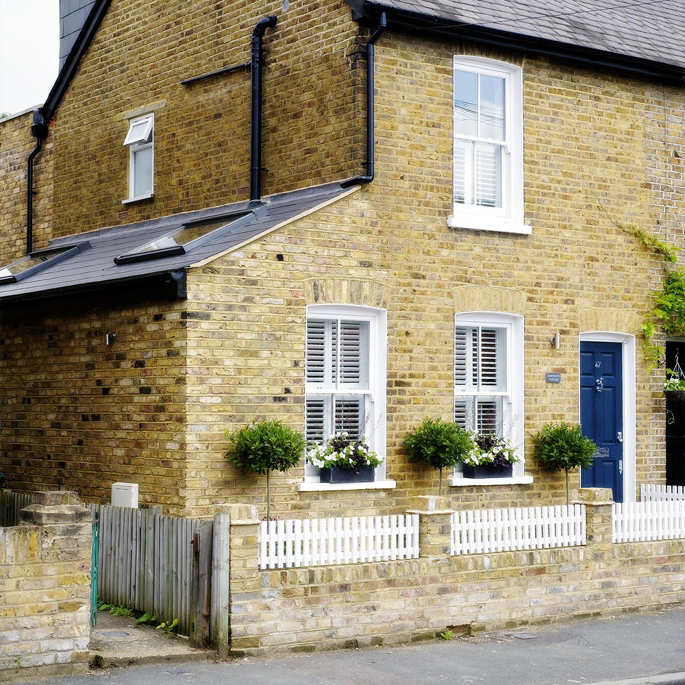 house exterior with brick wall and white window