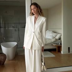 @anoukyve wearing a white suit